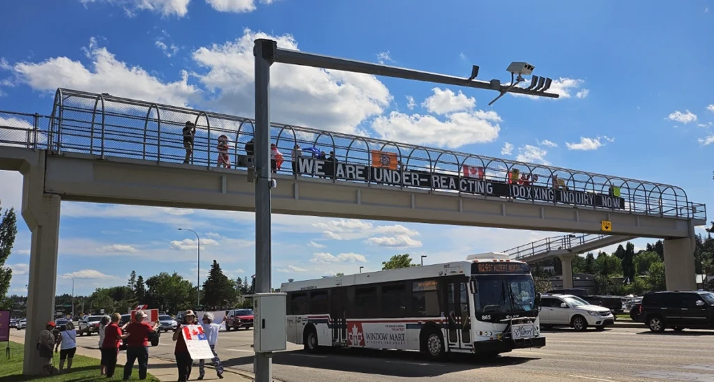 Fight Back Now Protest July 7th St.Albert Bridge sign "We are Under-reacting-Doxxing Inquiry Now"